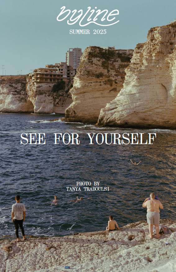 People by the ocean with cliffs and buildings in the background, featuring 'byline' magazine cover.